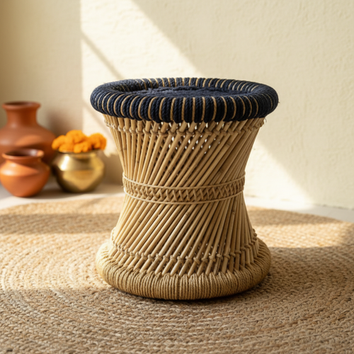 Bamboo mudda stool on a warm Himalayan-themed backdrop