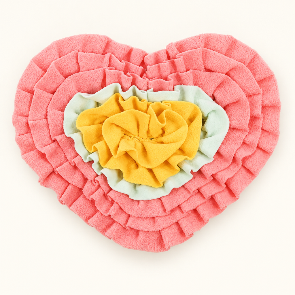 Pink heart-shaped dog snuffle mat with yellow and mint fabric folds