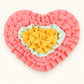Pink heart-shaped dog snuffle mat with yellow and mint fabric folds