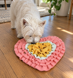 Westie using a pink heart-shaped snuffle mat indoors