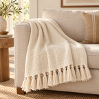 Cream handloom cotton throw draped over a neutral sofa