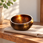 Hand-hammered bronze Nepal singing bowl on a natural cloth